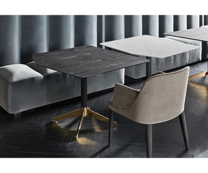 Designed by Massimo Castagna Coffee table with black open pore brushed stained ash top. Also available with tempered hand decorated Craquelé glass top. Black hand brushed anodised aluminum base with bright brass plated details.  Inches  (Ø x H) A 39½" × 18¾"  Inches (W x D x H) B - C - D 35½" × 35½" × 18¾"  E  41½” x 19¾” x 18¾”  Actual product may vary from images shown on website. Please contact info@rifugiomodern.com  for finish samples.