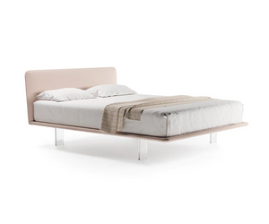Is available at Rifugio Modern. The cozy warmth of a comfortable nest: generous, wraparound volumes suggest total relaxation.   Harmoniously punctuated by a vertical rhythm, this bed’s proportions express themselves to the utmost degree in the headboard that embraces the entire height of the bed frame.  