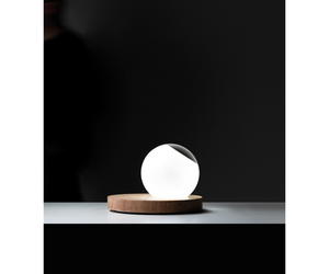 Omar Carragli Design for Davide Groppi Wood - Glass Table lamp with dimmer  Pigreco is rigorous in its design, putting together two essential, concrete and tangible materials: wood and glass. The crystal ball, in part made of frosted glass, can be positioned as one desires, functioning both as diffusor and convex lens. 24 V DC LED 6,5 W - 450 lm Actual product may vary from images shown on website. Please contact info@rifugiomodern.com  for finish samples. 