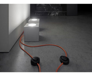 Designed by Alberto Zattin for Davide Groppi  Cement - Metal Floor lamp. Orange cable.  100-240 V - 50/60 Hz LED MAX 10 W - GU10 Actual product may vary from images shown on website. Please contact info@rifugiomodern.com  for finish samples. 