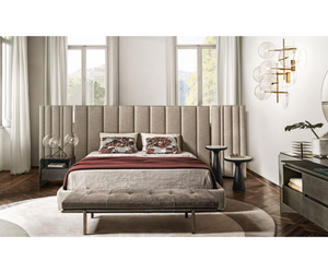 Designed by Massimo Castagna for Gallotti&Radice Bed in non-deformable foam polyurethane in different density and polyester fibre. Freestanding upholstered headboard with adjustable side panels. Wooden slats included. Available covered by fabric or leather as per sample. Satin brass details. USB charger ports version (one for each side) on request. Actual product may vary from images shown on website. Please contact info@rifugiomodern.com  for finish and fabric samples. 