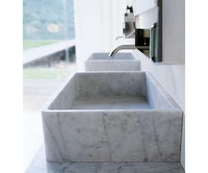 Designed by Benedini Association for Agape From white Carrara marble, an eternal material of art and architecture, comes this washbasin with a large basin and thin edges, supported by a stainless steel structure. Together with the other elements of the Agape collection Actual product may vary from images shown on website. Please contact info@rifugiomodern.com for fabric and finish samples.