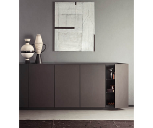 Elegant and sophisticated, the Cornice sideboard borrows its name from the eponymous wardrobe in the Pianca collection, scaling down its salient features to suit its new purpose. The element that gives the unit its character is the frame that runs round the edges of all the panels, punctuating the structure and drawing attention to the run of modules.  Actual product may vary from images shown on website. Please contact info@rifugiomodern.com for finish and fabric samples.