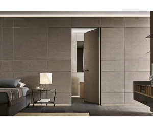 Careful and rigorous presence by definition, the Modulor wall paneling system acquires a highly expressive value with the exclusive Noce Sahara finish. The new glass Self sideboard and the aluminium shelves of the same system are the main protagonists at the centre of the space, while the swing doors are perfectly integrated into the background.  Actual product may vary from images shown on website. Please contact info@rifugiomodern.com for finish and fabric samples.