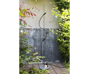 Designed by Benedini Association for Agape  Floor standing shower with support in black anodized aluminum and base in dark gray Cementoskin® (colored cement paste); the water supply elements are made of POM, a plastic material, with a black finish. The flexible hose, in black PVC, is complete with a quick coupling for the garden. The shower is equipped with flow regulation only.  Actual product may vary from images shown on website. Please contact info@rifugiomodern.com for fabric and finish samples.