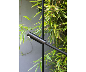 Designed by Benedini Association for Agape  Floor standing shower with support in black anodized aluminum and base in dark gray Cementoskin® (colored cement paste); the water supply elements are made of POM, a plastic material, with a black finish. The flexible hose, in black PVC, is complete with a quick coupling for the garden. The shower is equipped with flow regulation only.  Actual product may vary from images shown on website. Please contact info@rifugiomodern.com for fabric and finish samples.
