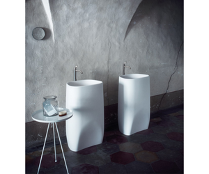 Designed by Patricia Urquiola for Agape  Made in white Cristalplant® biobased or in white Carrara, grey Carnic, black Marquina, green Alpi or Emperador dark marble, it echoes the unmistakable style of sanitary collection of the same name, dominating the space with its soft and strong volume, carved like a monolith. Available with floor or wall drain version.  Actual product may vary from images shown on website. Please contact info@rifugiomodern.com for fabric and finish samples.