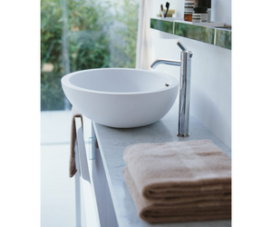 Designed by Benedini Association for Agape  Made of white Cristalplant® biobased, the Spoon and Spoon XL washbasins can give life to multiple compositional possibilities: for example in the countertop version on a Flat XL oak top. The enlarged shapes of Spoon XL maintain its essential and enveloping elegance unaltered.  Actual product may vary from images shown on website. Please contact info@rifugiomodern.com for fabric and finish samples.