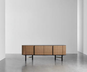 Designed by Federico Peri for Gervasoni  Sideboard with plywood and MDF lacquered body. Four doors upholstered in water-repellent and cleanable ecoleather One or two internal adjustable shelves. Top available in two options: 6 mm porcelain stoneware; 6 mm glass painted below. Elliptical-section legs made of lacquered solid wood and connected by steel bars.  Actual product may vary from images shown on website. Please contact info@rifugiomodern.com for finish and fabric samples.